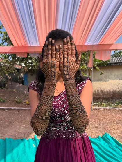 Another view of the full back-hand bridal mehendi, highlighting the symmetry and consistency of the patterns across both arms.