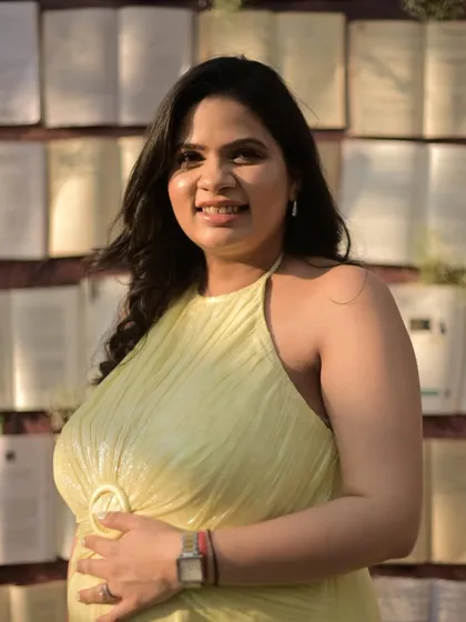 Posing against a unique backdrop of books, this mommy-to-be looks serene and beautiful. Her makeup is natural, with a focus on highlighter to catch the light.
