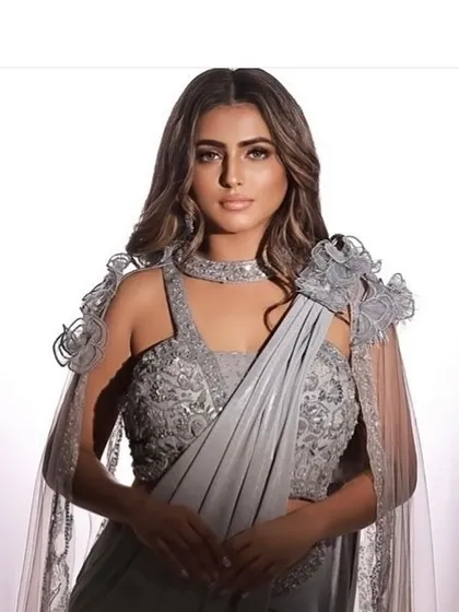 A beautiful portrait from a designer photoshoot. The makeup is soft yet glamorous, enhancing the model's features without overpowering the elegant outfit.