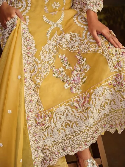 Shine bright in this yellow organza Anarkali suit. The heavy white thread embroidery and sequin work make it a perfect outfit for a Haldi ceremony or festive celebration.