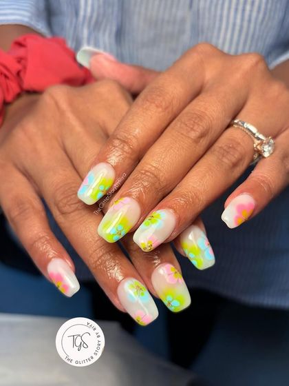Perfect for a beach vacation, this watercolor-style nail art uses bright neon pigments on a milky white base to create a vibrant, abstract look.