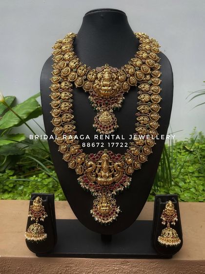 A classic Lakshmi temple jewellery set. This rental piece features a choker and a long haram made of interconnected Lakshmi coins, creating a divine and traditional look.