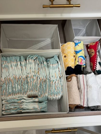 A drawer organized for baby essentials. We created dedicated compartments for diapers, wipes, and bibs, ensuring everything is within arm's reach during changing time.