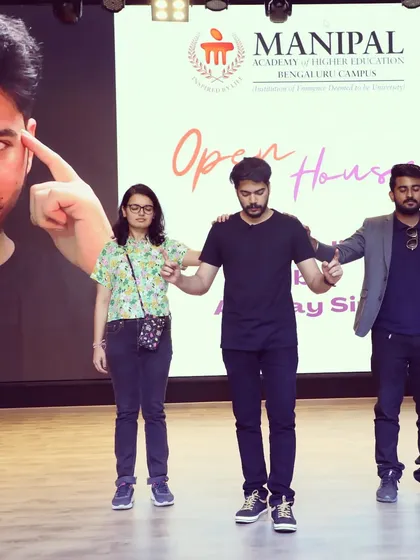 On stage at Manipal University, I'm performing a paranormal touch illusion. This act involves multiple participants and creates a powerful, shared experience of the unexplained that captivates the entire auditorium.