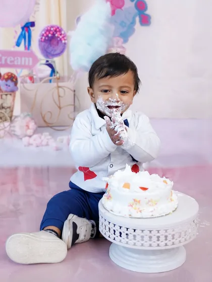 The aftermath of a successful cake smash. This photo captures the pure, uninhibited joy of making a glorious mess.