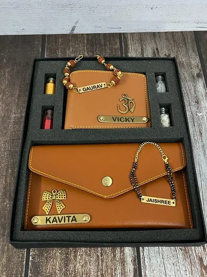 Celebrate the special bond with this matching Bhai-Bhabhi Rakhi set. It includes personalized faux leather wallets for both, a Rudraksha rakhi for him, and a mangalsutra-style bracelet for her, all presented in a premium gift box.