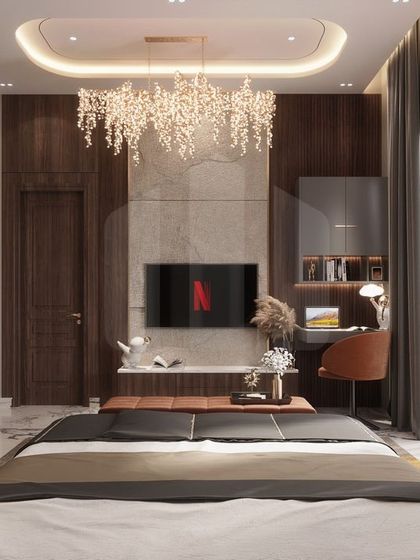 This luxury bedroom features a stunning cascading chandelier that serves as a focal point above the bed. The room also includes a compact study desk, demonstrating our ability to integrate multiple functions into a single, cohesive, and high-end design.