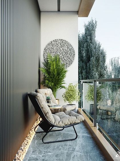 A minimalist balcony design that feels calm and uncluttered. A comfortable lounge chair, a few well-placed plants, and a piece of wall art are all it takes to create a stylish retreat.