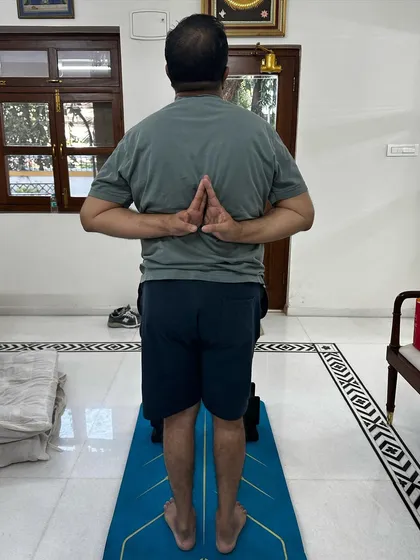 After a year of consistent practice, I'm thrilled to see my client's progress in managing his gout. Here he is in a reverse prayer pose.