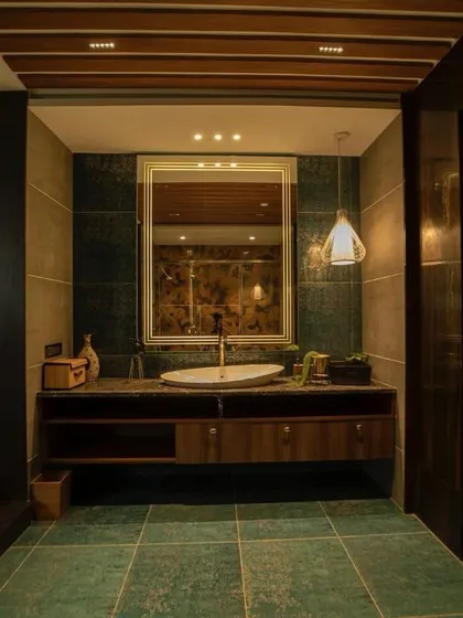 Part of our rustic interiors collection, this bathroom features dark wood paneling and green floor tiles, creating a moody and sophisticated atmosphere.