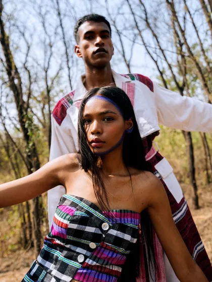 A powerful dual portrait from the "Nazaar" series. The models' direct gazes and the natural lighting create an intense and engaging image set within a forest.