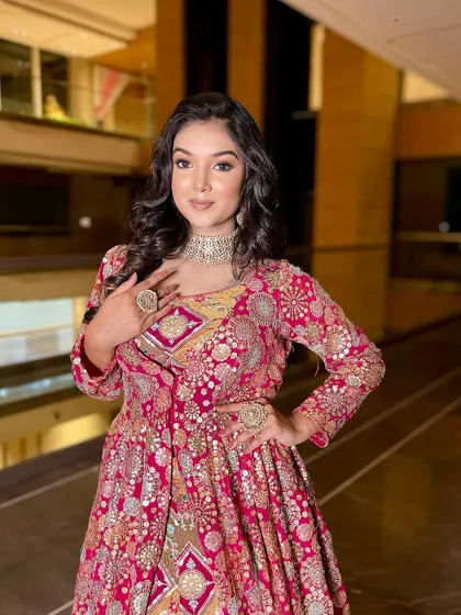 A confident pose. The makeup, hair, and outfit all come together for a stunning Sangeet look.