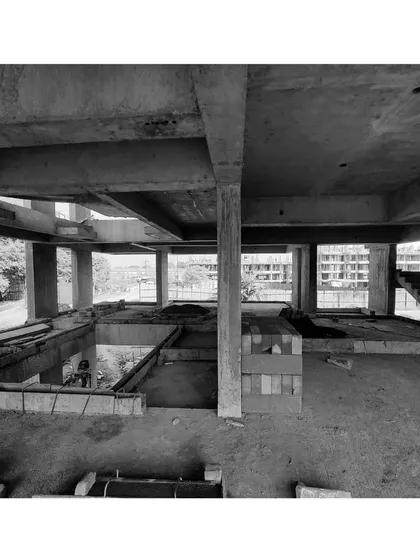 A black and white photo of a construction site, showing the bare concrete structure. This is the blank canvas from which we begin to shape and define interior spaces.