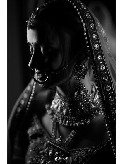 A timeless black and white portrait of a bride, her face in partial shadow.