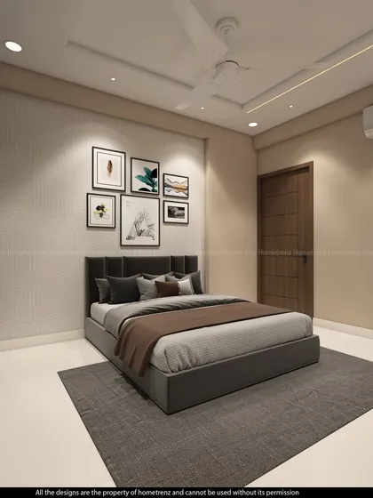 This guest bedroom uses a gallery wall of framed art to add personality. The dark upholstered bed and mirrored wardrobe create a chic and contemporary look.