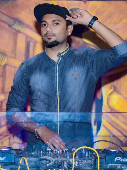 A confident stance at the console. This is my domain, where I blend confidence with skill to deliver a powerful performance.