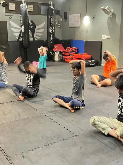 An instructor leads the class in cool-down stretches. Guided recovery ensures everyone is using the correct form to get the maximum benefit.
