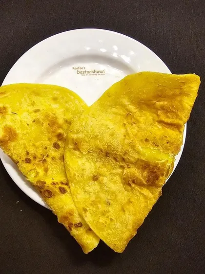 A plate of classic Baida Roti, a savory pancake stuffed with a flavorful mixture. It's a popular street food classic that I serve as part of my Nawabi cuisine offerings.