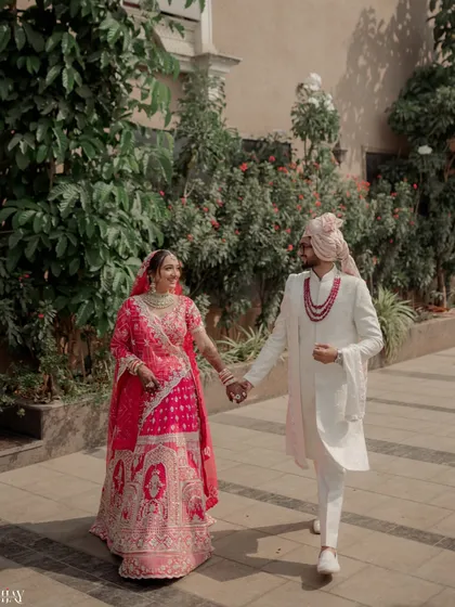 A happy moment as the newly married couple walks hand-in-hand after their ceremony.