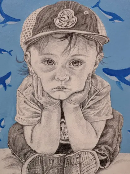 The completed ballpoint pen portrait of a child, with the addition of blue whale motifs in the background, creating a unique and imaginative piece.
