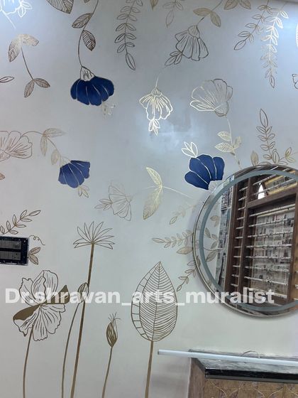 This gold foil artwork went viral, and it's easy to see why. The combination of delicate line drawings, bold blue flowers, and shimmering gold on a clean white wall is both modern and timeless.
