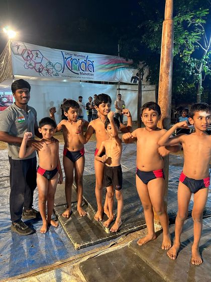 Our young champions from the Under-10 team flex their muscles after winning the Team Championship Gold. This photo captures their youthful energy and the strength they've built through their training.