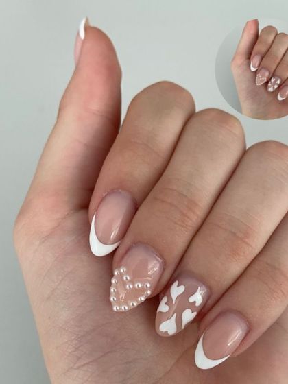 Another view of this adorable white French manicure with mixed accent nails, including a 3D pearl heart and tiny painted hearts.