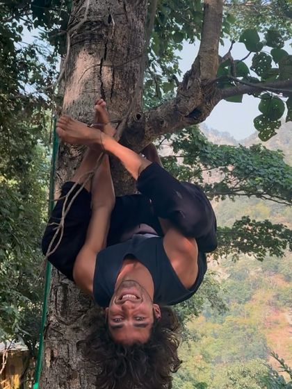 A participant playfully hanging upside down from a tree during our hike. Moments like these remind us to connect with our inner child and find joy in the simple things.