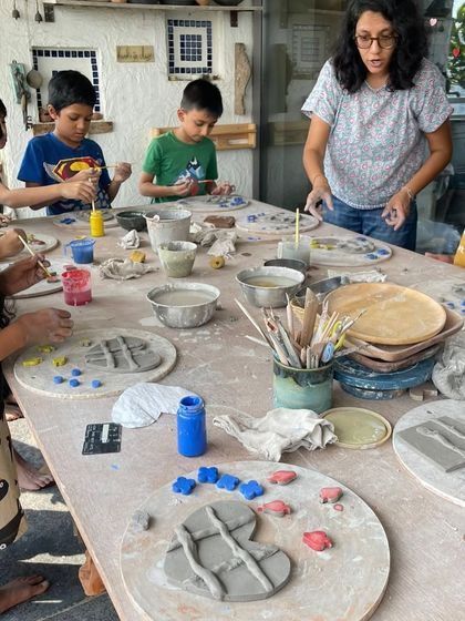 A group of young artists hard at work during our kids' pottery workshop. We provide all the tools and guidance they need to create.