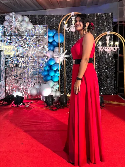 A full-length shot of my 'Laal Pari' look for a milestone birthday party, standing against a shimmering backdrop.