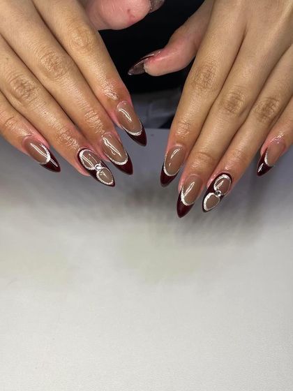 A unique design featuring a brown base with a deep red French tip and 3D silver accents, creating a modern and edgy look.