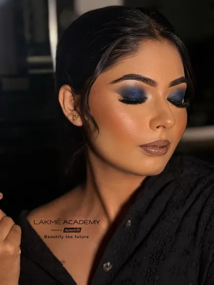 The closed-eye view of the blue smokey eye, demonstrating the seamless blending from the dark lash line to the soft crease. This level of detail is what separates a professional from an amateur.