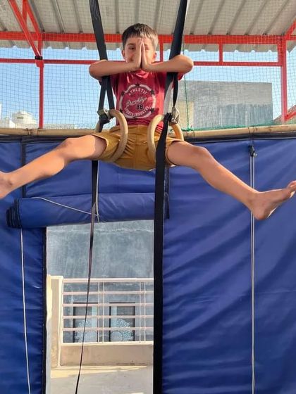 Finding a moment of calm and focus, even while suspended on the rings. This teaches kids body awareness and control.