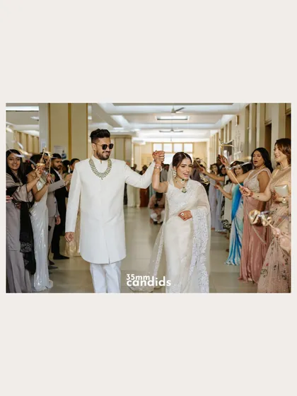 A happy exit for the newlyweds, walking through a tunnel of friends and family cheering them on. A perfect "happily ever after" moment.