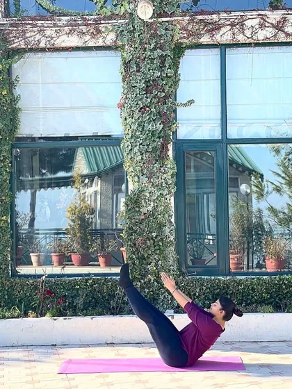 Practicing a balancing pose outdoors. This requires even more focus and stability. My classes help you build this foundation, whether you are a beginner or have been practicing for years.