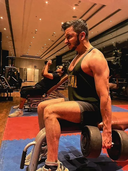Fearless pursuit of success. The intensity you see here during a seated dumbbell curl is what it takes to force muscles to grow.
