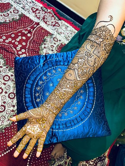 A full-arm view of a classic Indian bridal design. The patterns are dense and full of traditional motifs.