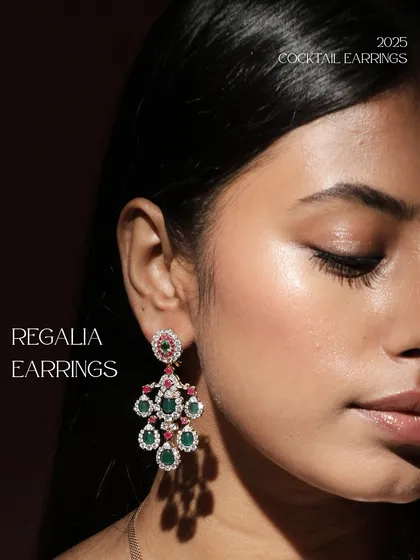 The Regalia Earrings, a stunning example of a cocktail earring that combines emeralds, rubies, and diamonds in a classic chandelier design for a look of timeless elegance.