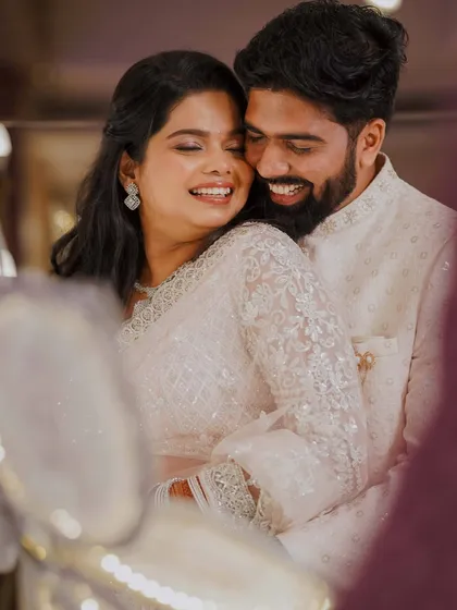 A beautiful, happy moment between the newly engaged couple. Her airbrush makeup in soft, neutral tones creates a timeless and elegant look.