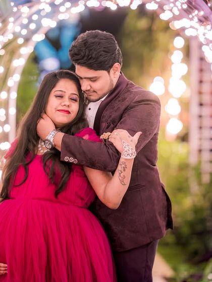 A tender moment between an expecting couple, framed by the warm glow of the light tunnel, perfect for a romantic maternity shoot.