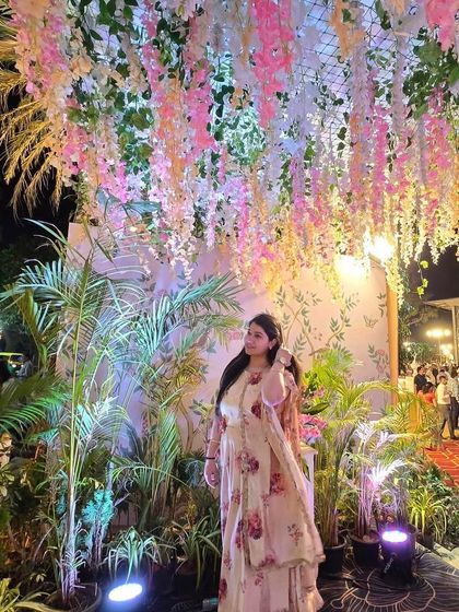 Another angle from a beautiful wedding event, filled with lush greenery and floral decor. The setting is a big part of the performance's story.