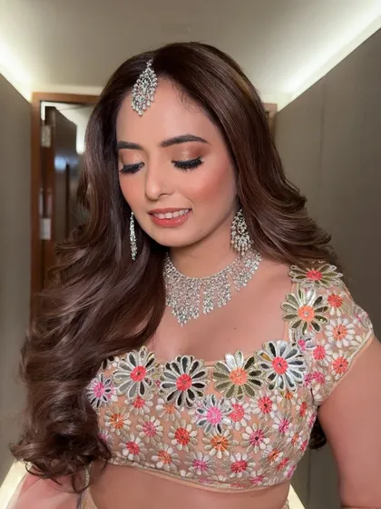 A close-up of the finished eye makeup. The soft, shimmery tones make her eyes sparkle, and the overall look is fresh and youthful.