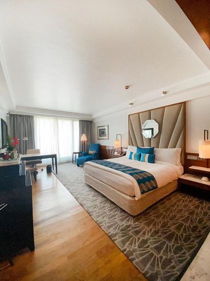 In this view of the Intercontinental Mumbai suite, the focus is on the serene sleeping area. We designed the upholstered headboard and complementary teal and patterned bed linens to create a restful yet stylish retreat.