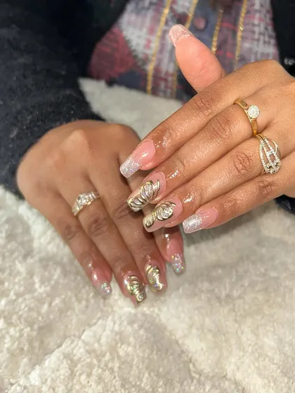 This client chose a combination of glitter French tips and 3D chrome shell designs. It shows how you can mix and match techniques for a custom look.
