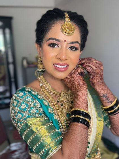 A beautiful portrait of this bride, her makeup looking soft and glowing, with a focus on her happy expression.