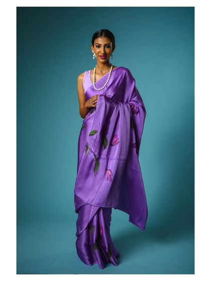 Another view of this elegant purple saree, showing the drape and flow of the fabric. Providing multiple angles helps customers visualize the product better.