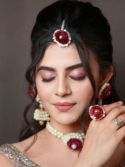Another beautiful shot of the sangeet look, with the model's eyes closed to showcase the eyeshadow. The floral ring is a lovely detail.