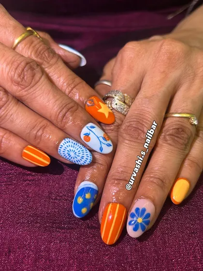 Sometimes you just need a fun pop of color. I hand-painted these quirky patterns using a vibrant orange and blue palette. This set shows how we can play with different designs on each nail to create something truly unique and full of personality.