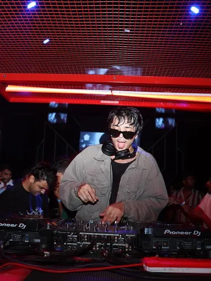 Performing at Sunburn Union in Bangalore. The red cage-like DJ booth adds to the unique, industrial vibe of the party.