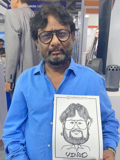 Drawing a guest at the NESCO exhibition centre in Goregaon. Branded caricatures are an effective and fun way to increase brand recall long after the event is over.